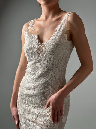 Elegant mermaid lace wedding dress featuring deep V neckline and floral detailing, ideal for modern brides.