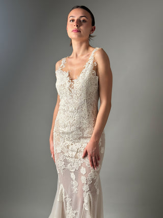 Elegant mermaid floral lace wedding dress with deep V neckline and open back, showcasing intricate lace details.