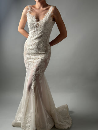 Elegant mermaid wedding dress with floral lace, deep V neckline, and open back design, perfect for modern brides.