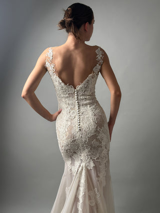 Elegant bridal mermaid lace wedding dress with deep V neckline and open back detail, showcasing floral lace design.