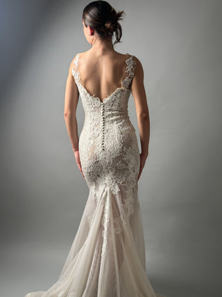 Elegant mermaid wedding dress with floral lace and open back, showcasing a romantic design.